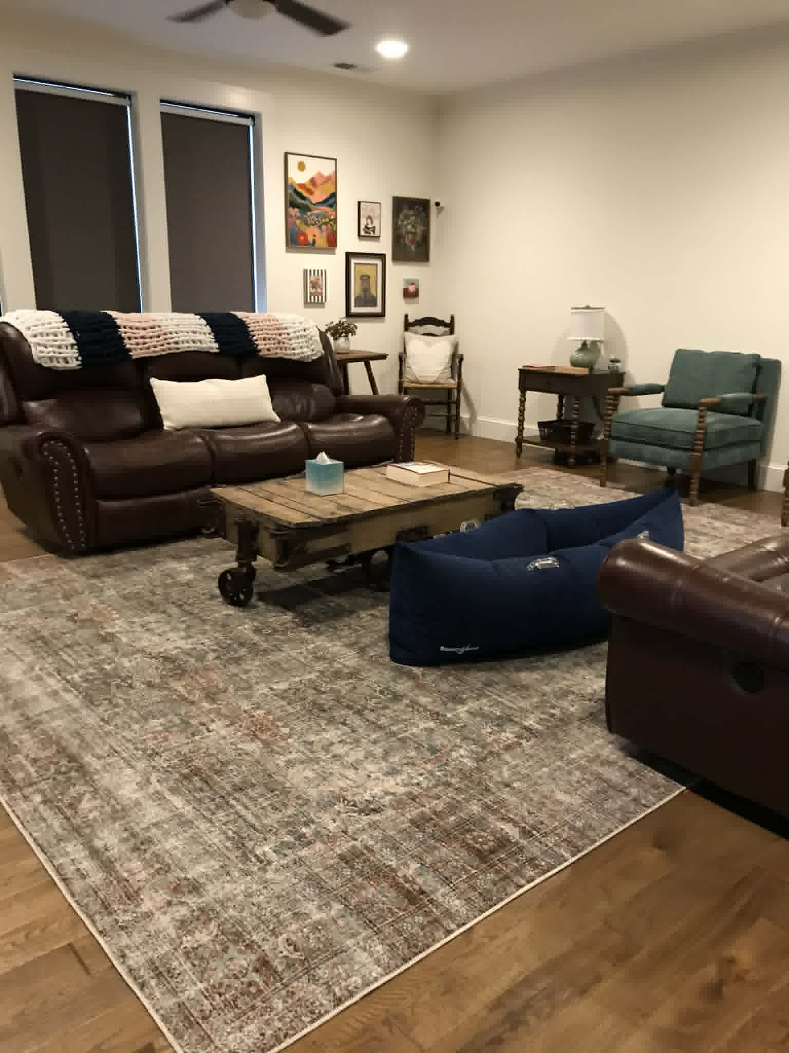 Clean living room with leather sofas and rustic coffee table