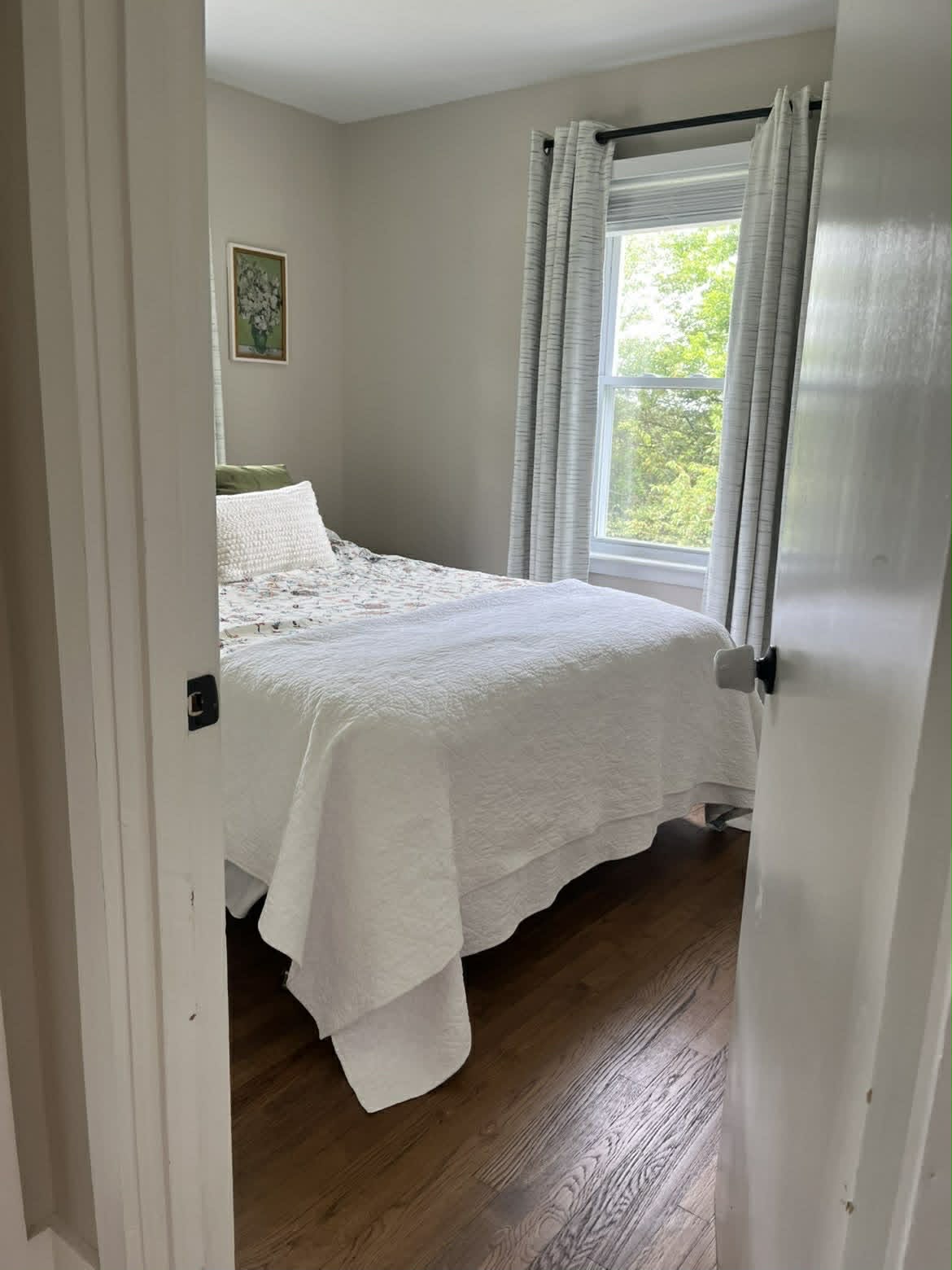 Clean small guest bedroom through doorway