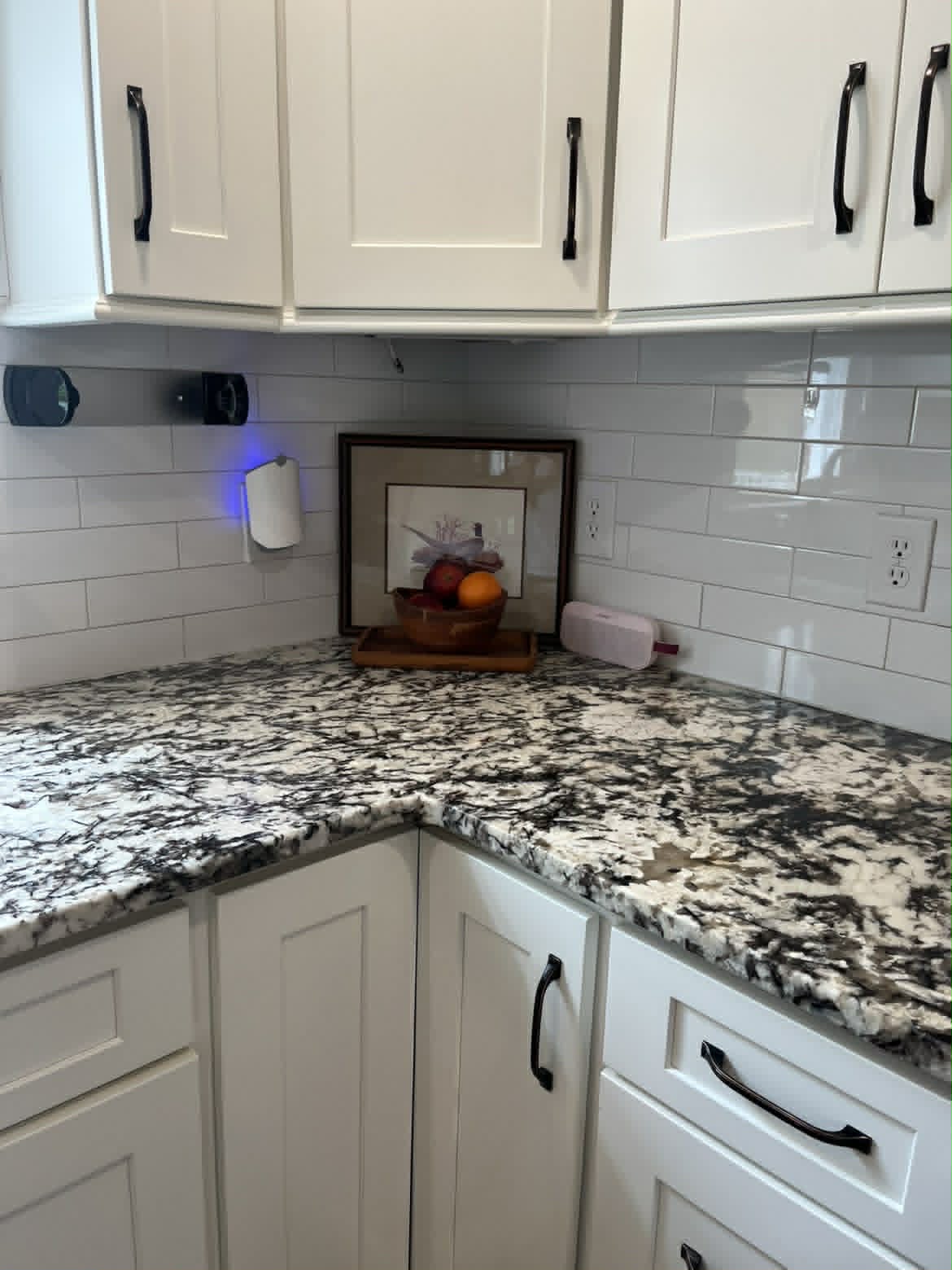 Clean white kitchen counter with under-cabinet lighting