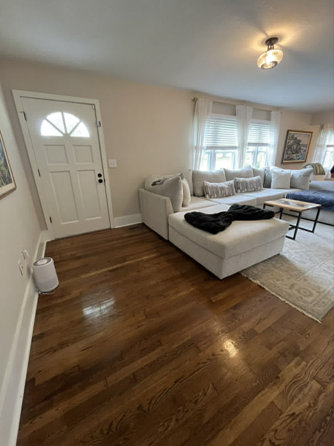 Living room with beige sectional viewed from entryway