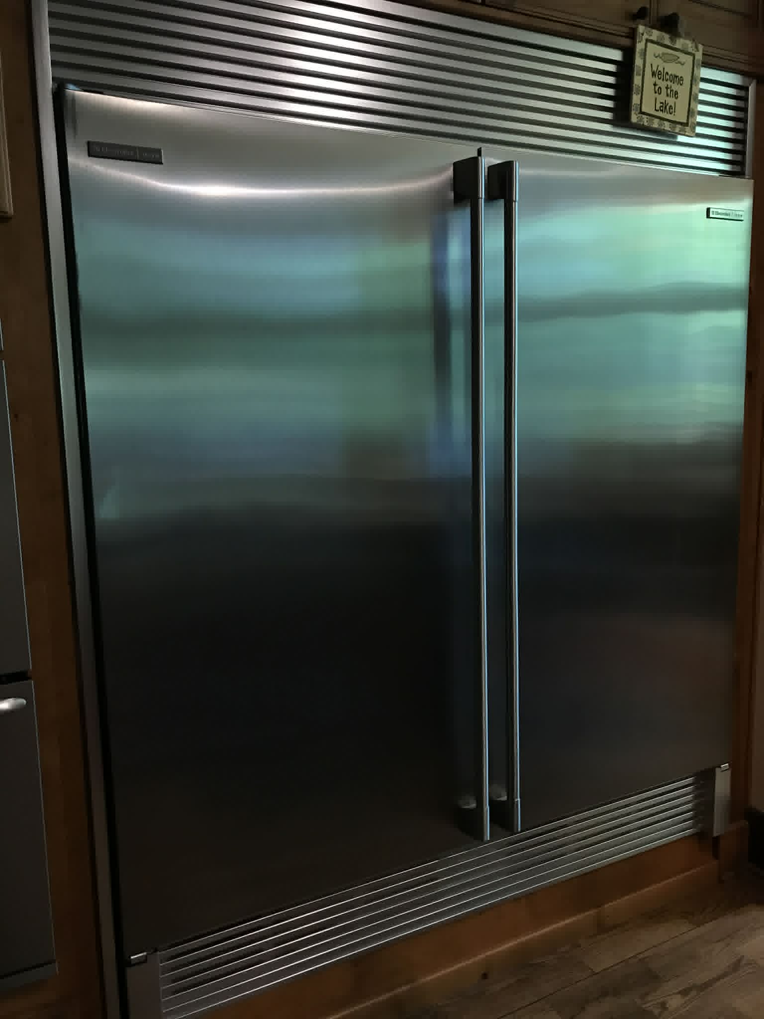 Stainless steel refrigerator in lake house kitchen