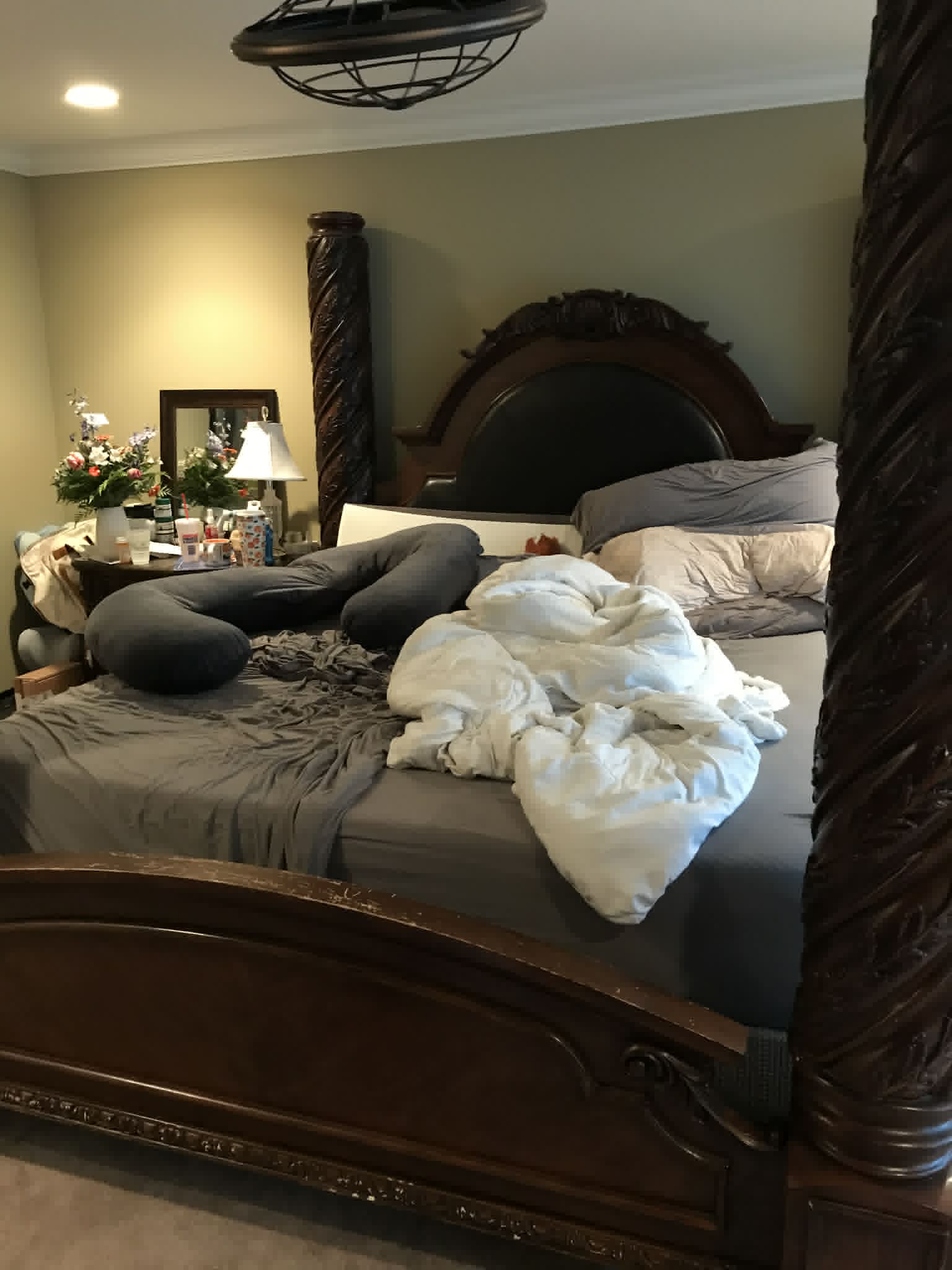 Master bedroom before cleaning — unmade bed, tangled bedding
